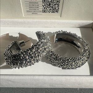 Circular design story silver hoop earrings